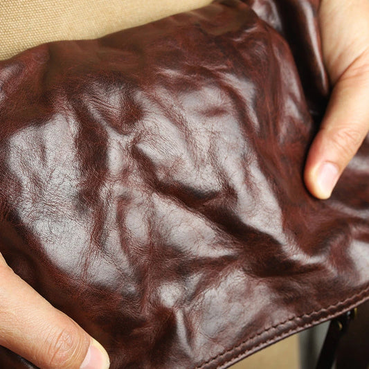 Handmade vintage-inspired leather crossbody bag with ruffled design and zipper closure