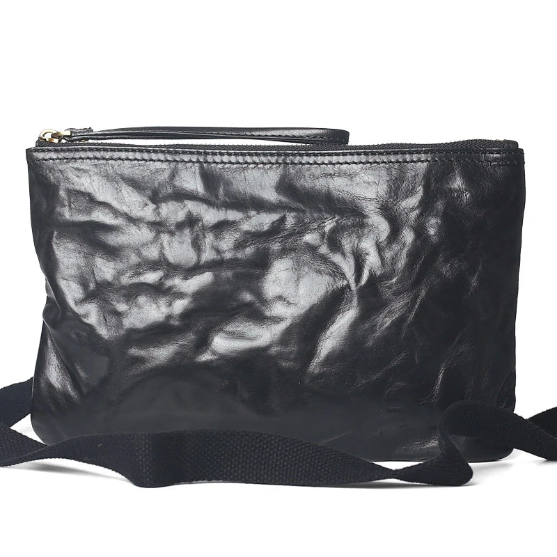 Handmade vintage-inspired leather crossbody bag with ruffled design and zipper closure