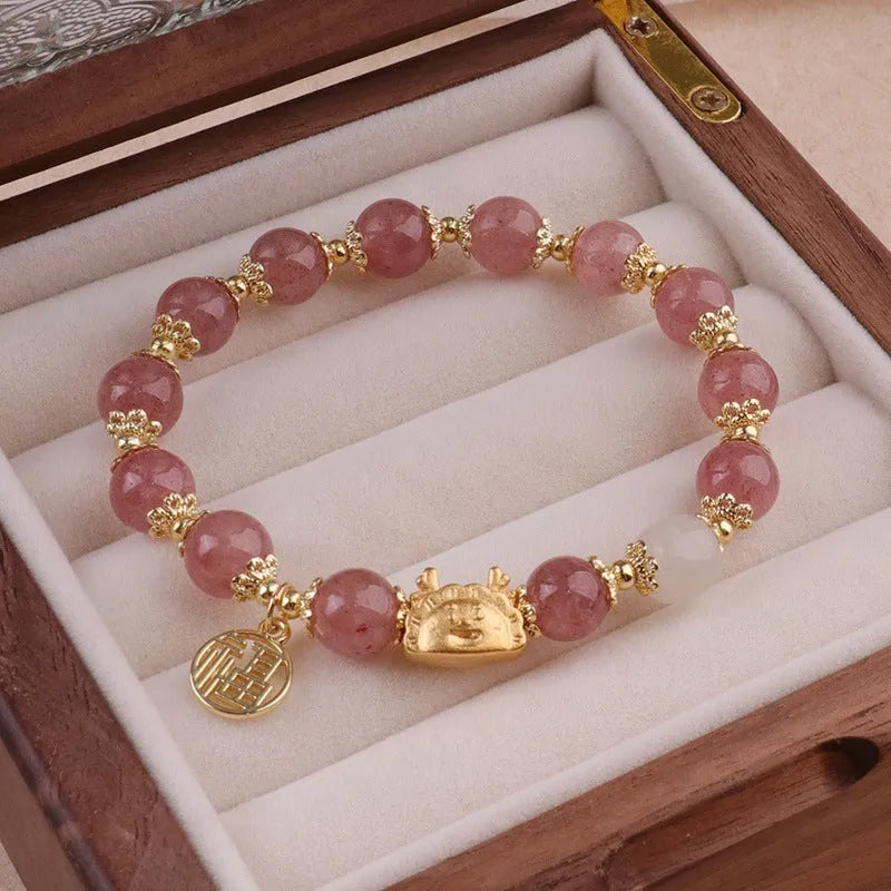 A women's glass glazed bracelet with floral and zodiac animal charms in red, pink, and white pearl beads.