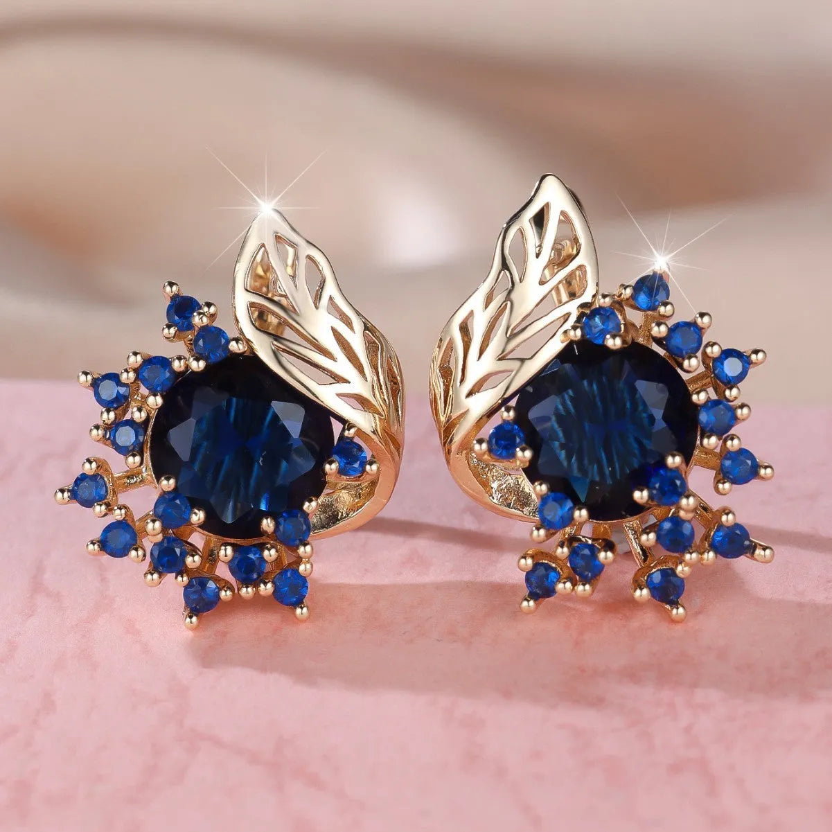 Round flower and feather design earrings in champagne gold with a choice of coloured zircon stones.