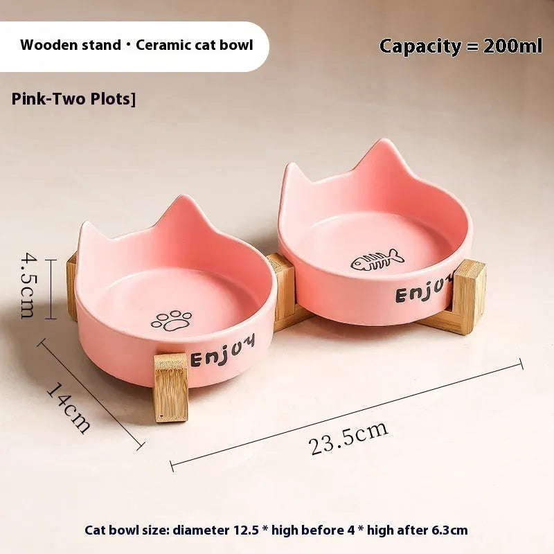 Porcelain cat bowl with anti-tumble wooden frame in pink with a cat paw design