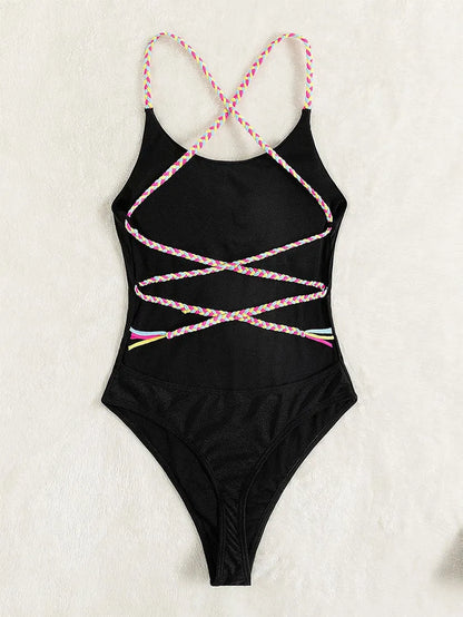 Black women's one-piece backless nylon swimsuit on a hanger