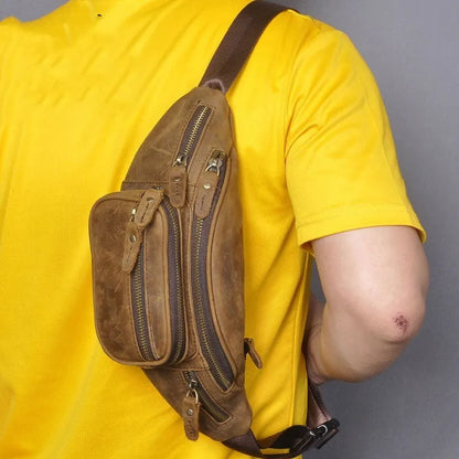 Retro style brown cowhide leather messenger bag with a single shoulder strap.