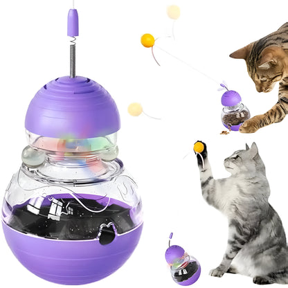 Multi-functional cat toy with tilting base, teaser wand with ball and ribbon, and food dispenser opening