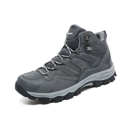 Low-top hiking sneaker in multiple colours on a rocky mountain path, showing lace-up front and rubber sole.