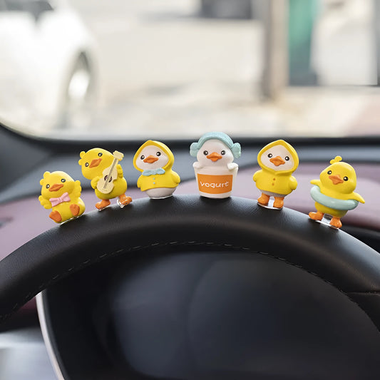 Set of six small yellow PVC duckling figures and one rectangular 'Hello' sign for car dashboard decoration.
