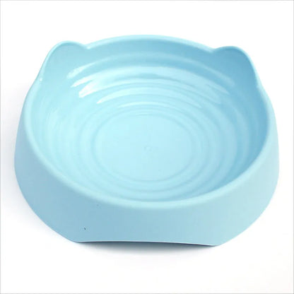 Blue ceramic dog bowl with raised central maze design for slowing fast-eating dogs.