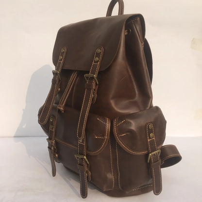 Men's brown leather backpack showing cowhide texture and air pillow belt system