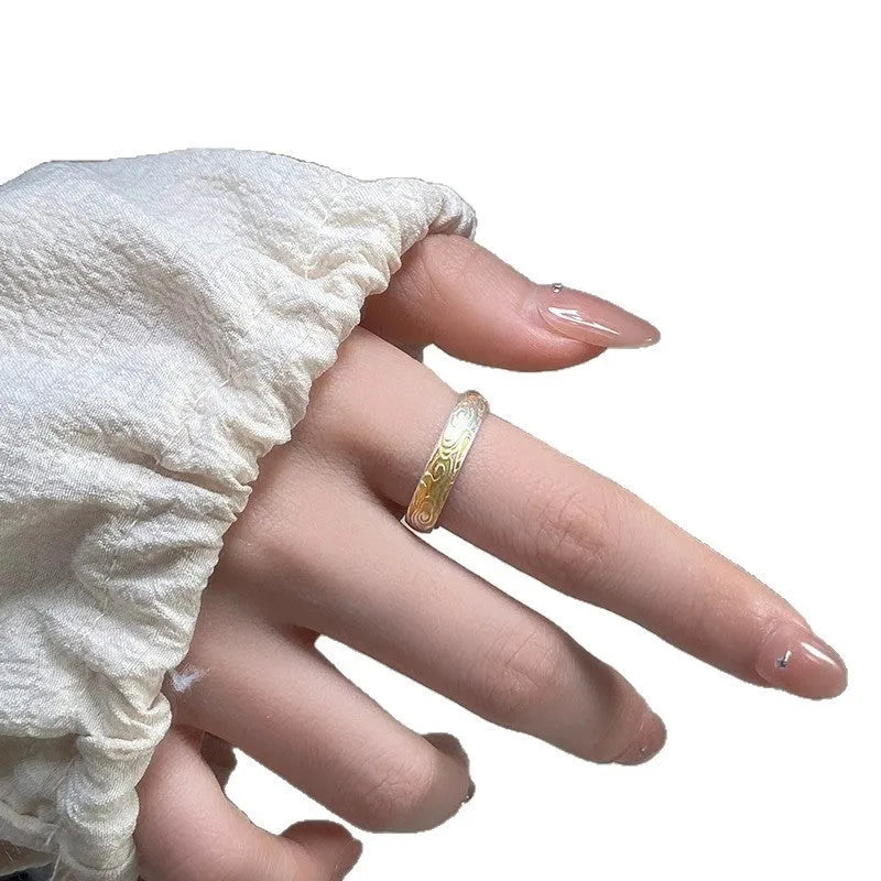 Open mouth silver and gold ring with J14 Xiangyun geometric pattern on a white copper band.