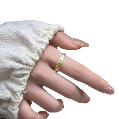 Open mouth silver and gold ring with J14 Xiangyun geometric pattern on a white copper band.
