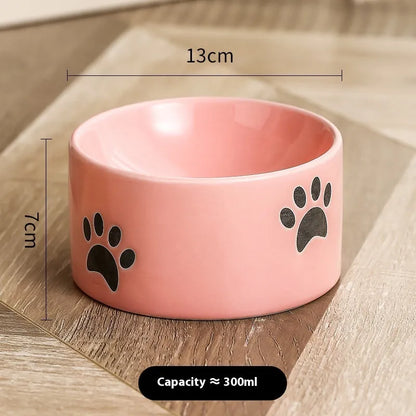 Ceramic cat bowl with high foot and cat's paw base in an oblique mouth design.