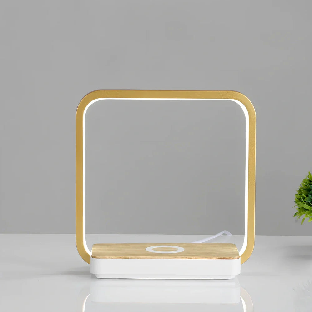 Modern bedside lamp with wireless charging pad and adjustable LED lighting in gold finish