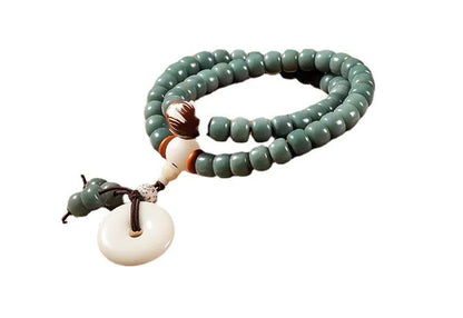 White jade bodhi and green sandalwood bracelet with a double ring safety buckle clasp.