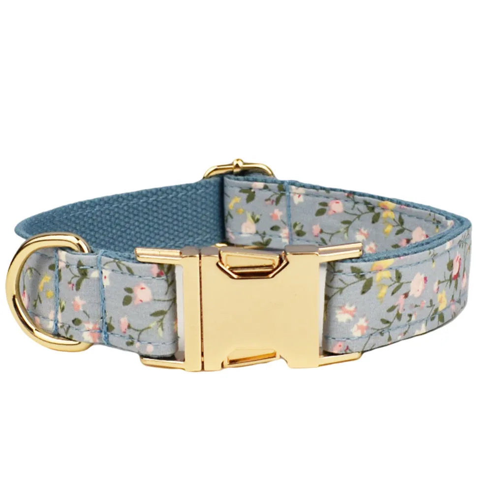 Blue floral dog collar set with adjustable sizes, includes leash, vest, bow, and poop bag on polyester cotton cloth.
