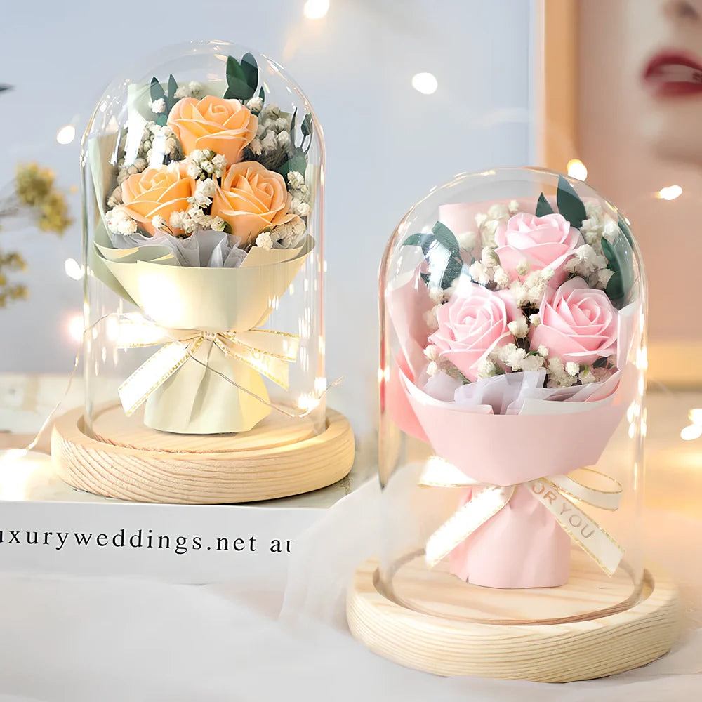 Soap flower bouquet in glass display cover with red roses visible through clear 11.2cm dome