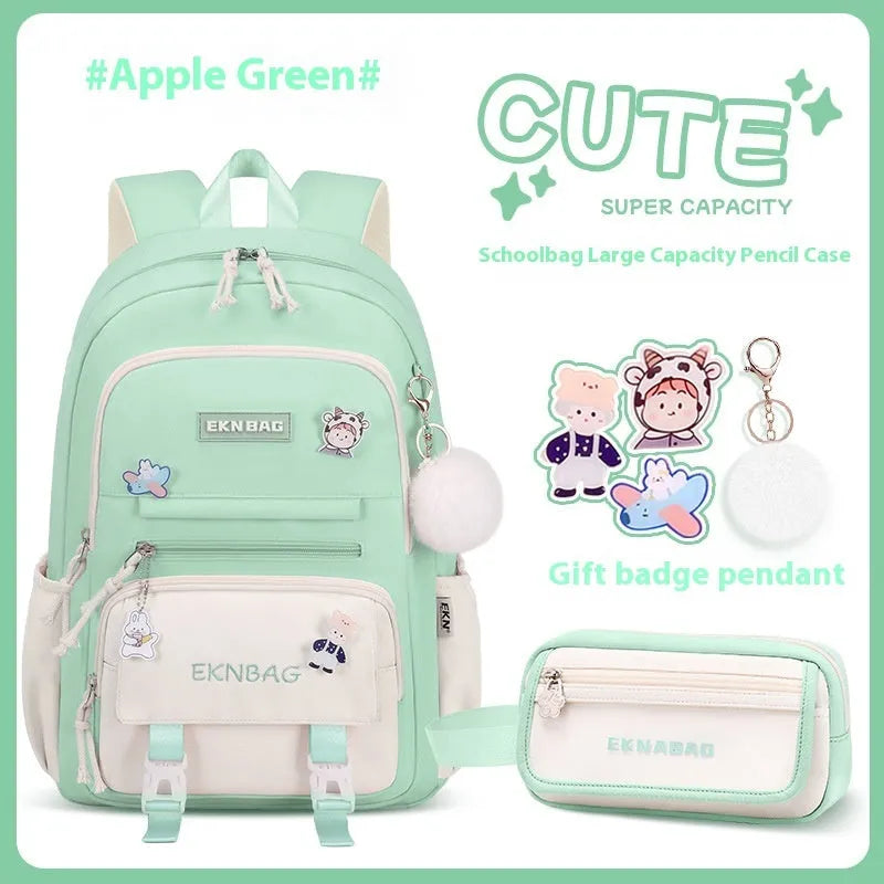 Pink waterproof Oxford cloth school backpack for girls with curved shoulder straps, shown with matching pencil case.