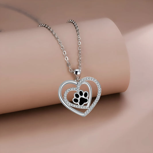 Copper heart pendant necklace with engraved dog paw print on a cross chain.