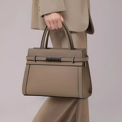 Women's square genuine leather crossbody handbag in clamshell style with internal compartments.