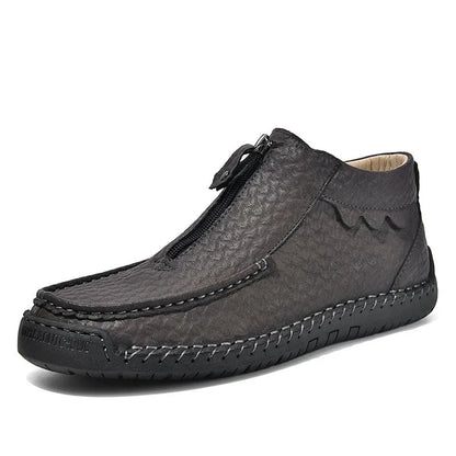 Men's slip-on loafers in black with round toe and sewing thread details, showing rubber sole