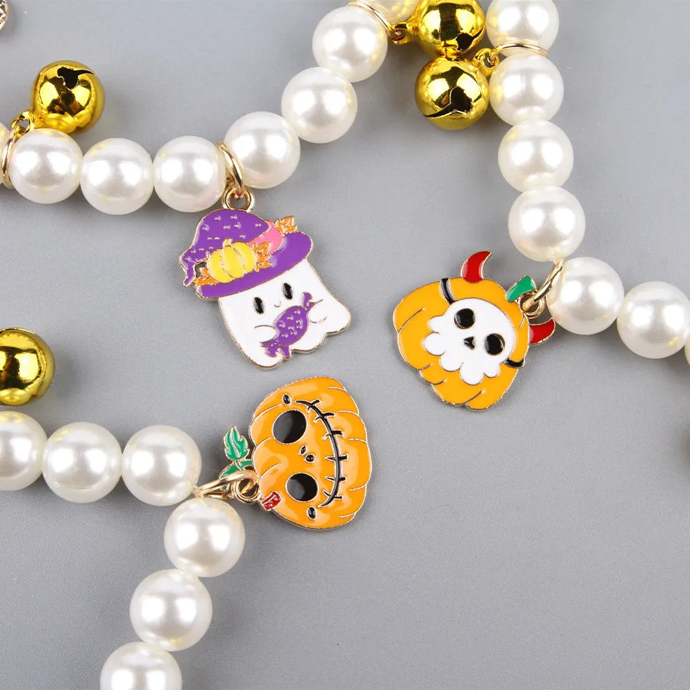 Halloween cat collar with simulated pearls and pumpkin-shaped charms in purple ghost, skull, and smiling designs.