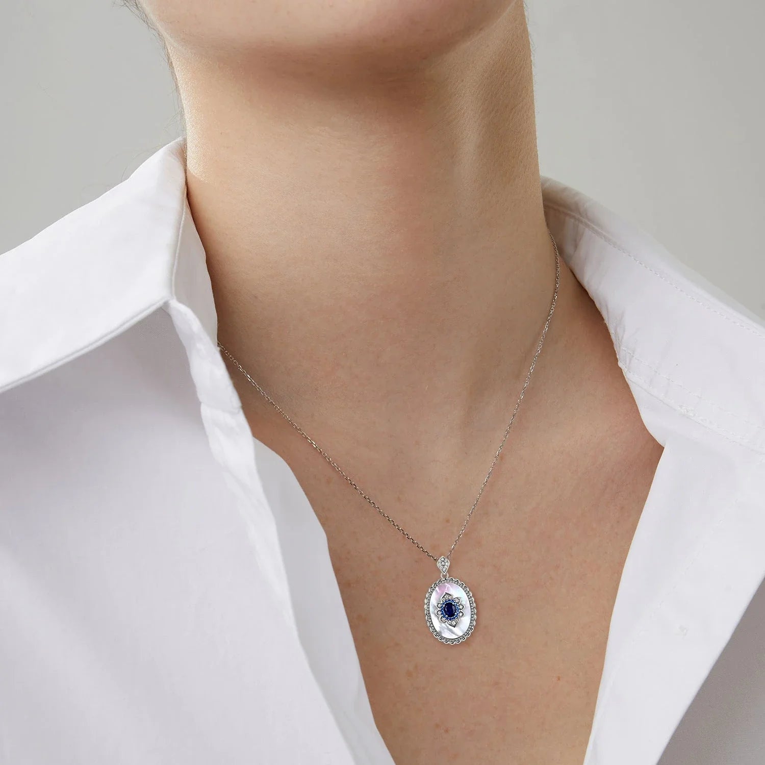 Elegant sapphire and diamond pendant necklace made of 925 sterling silver with a sleek geometric design and O-chain