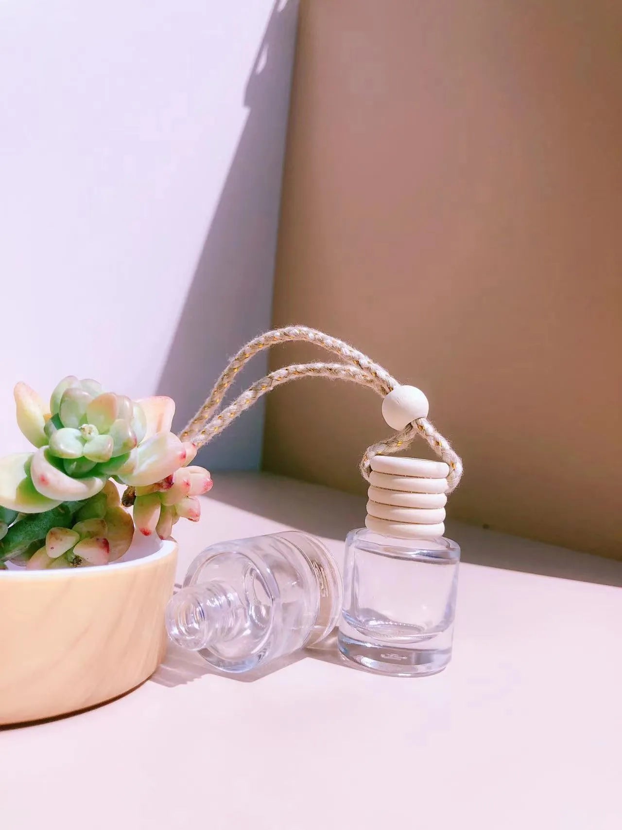 Car perfume pendant in four glass bottle styles: cylinder, diamond, flat drum, and square