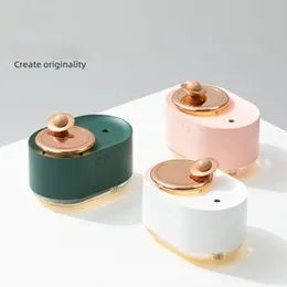 Rotating planet-shaped humidifier in green colour with USB cable and mist emitting from the top.
