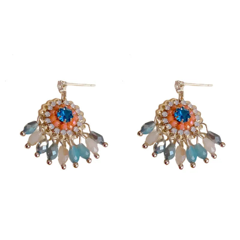 Gold plated geometric earrings with blue diamond-embedded crystals in tassel design