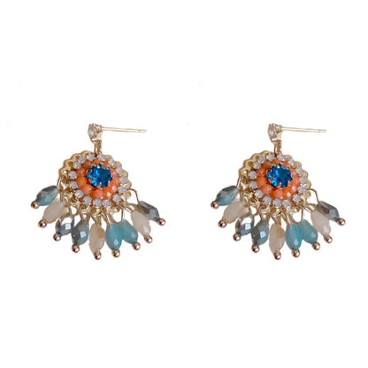 Gold plated geometric earrings with blue diamond-embedded crystals in tassel design