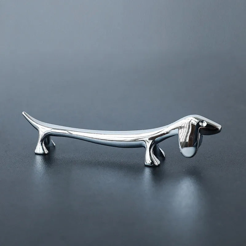 Silver sausage dog chopstick rest and cutlery holder made from zinc alloy with coating for chopsticks, knives or forks