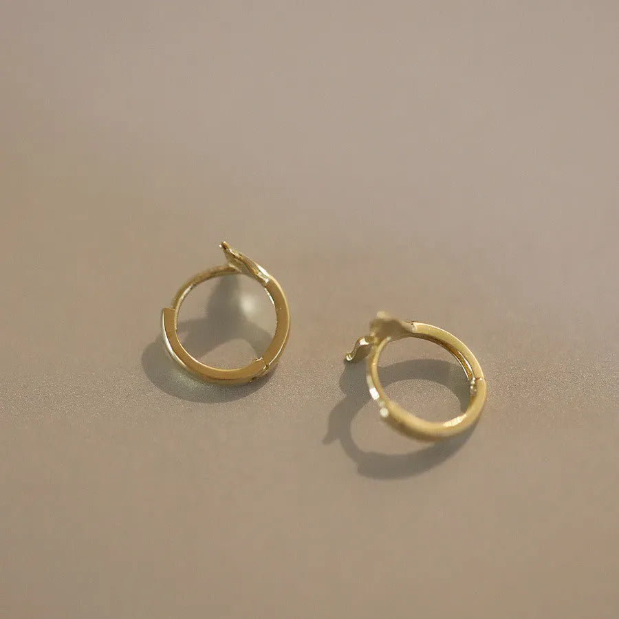 Pair of S925 sterling silver fishtail earrings with 14k gold plating in gold colour.