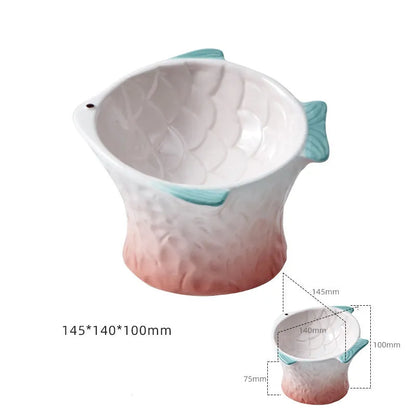 Set of four blue fish-shaped ceramic cat bowls on a kitchen worktop, showing their raised, tilted design.