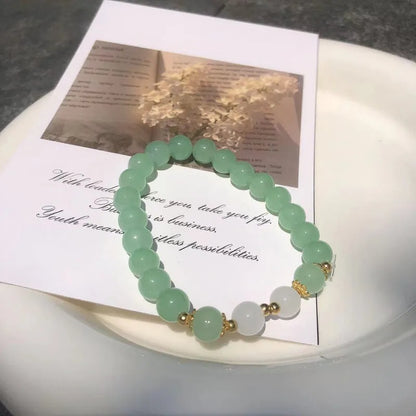 Chinese style glass bead bracelet with bamboo joint design on wrist.