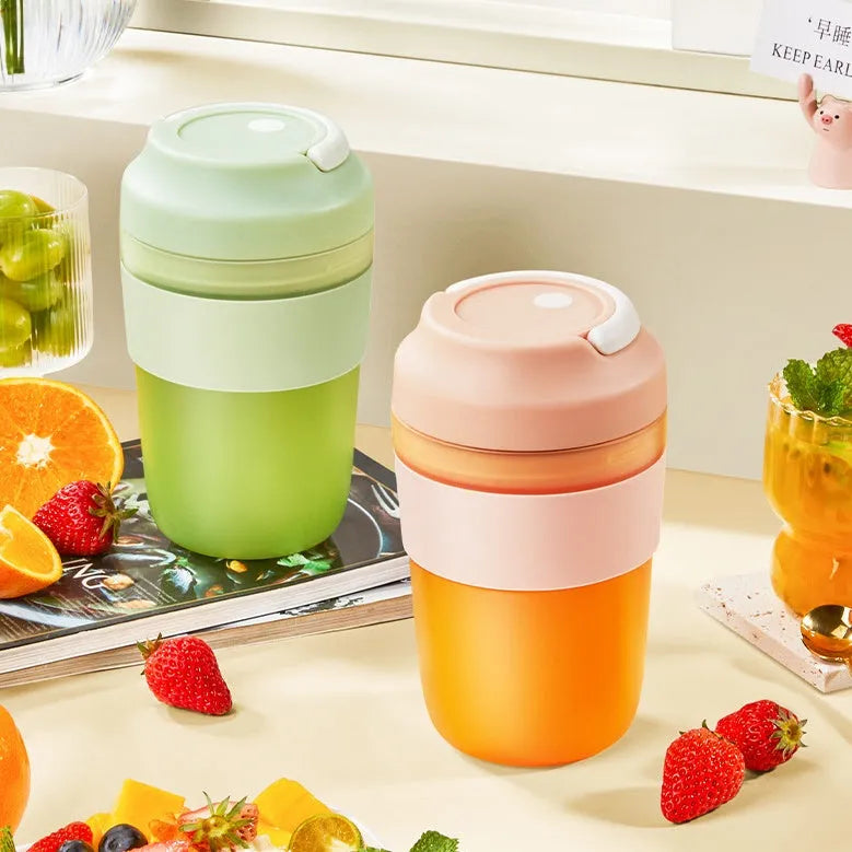 Green portable USB rechargeable blender cup with lid and four stainless steel blades, 400ml capacity.