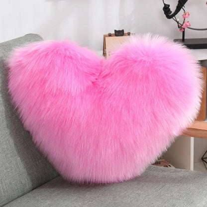 Cozy heart-shaped plush throw pillows in various colors and sizes for living room and bedroom decor