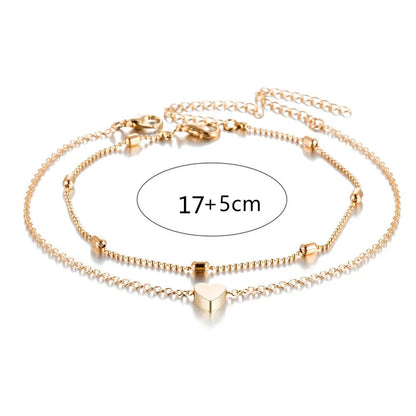 Trendy heart-shaped anklet with double-layered design and retro beach ball chain in gold, silver, and silvery colors.