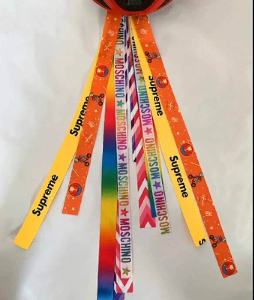 Children's helmet streamer with 60 cm polyester ribbon in colours like apricot and khaki for roller skating and skiing