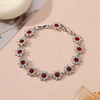 Floral shaped zinc alloy bracelet with electroplated colourful gem finishes in gold and silver tones.
