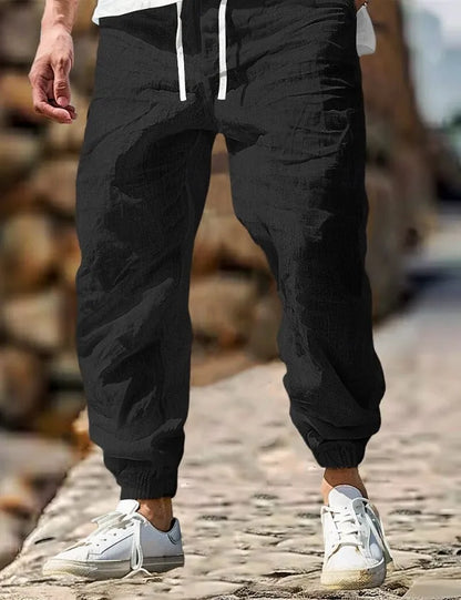 Men's straight-leg cotton trousers with elastic waist in Army Green colour, showing classic fit and summer-appropriate fabric.