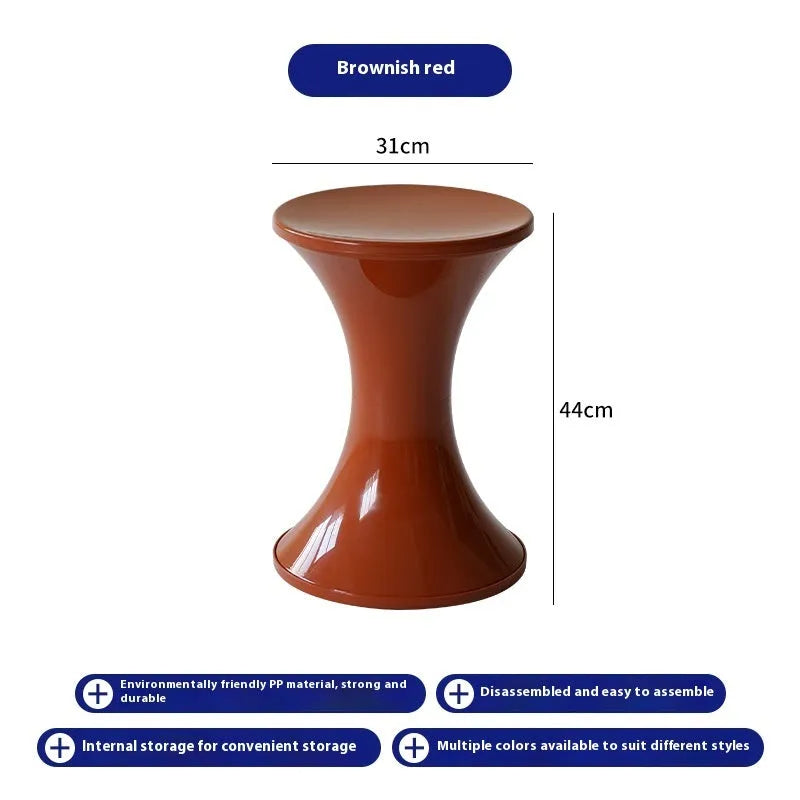 Plastic hourglass-shaped shoe changing stool in green, 40cm high and 30cm wide