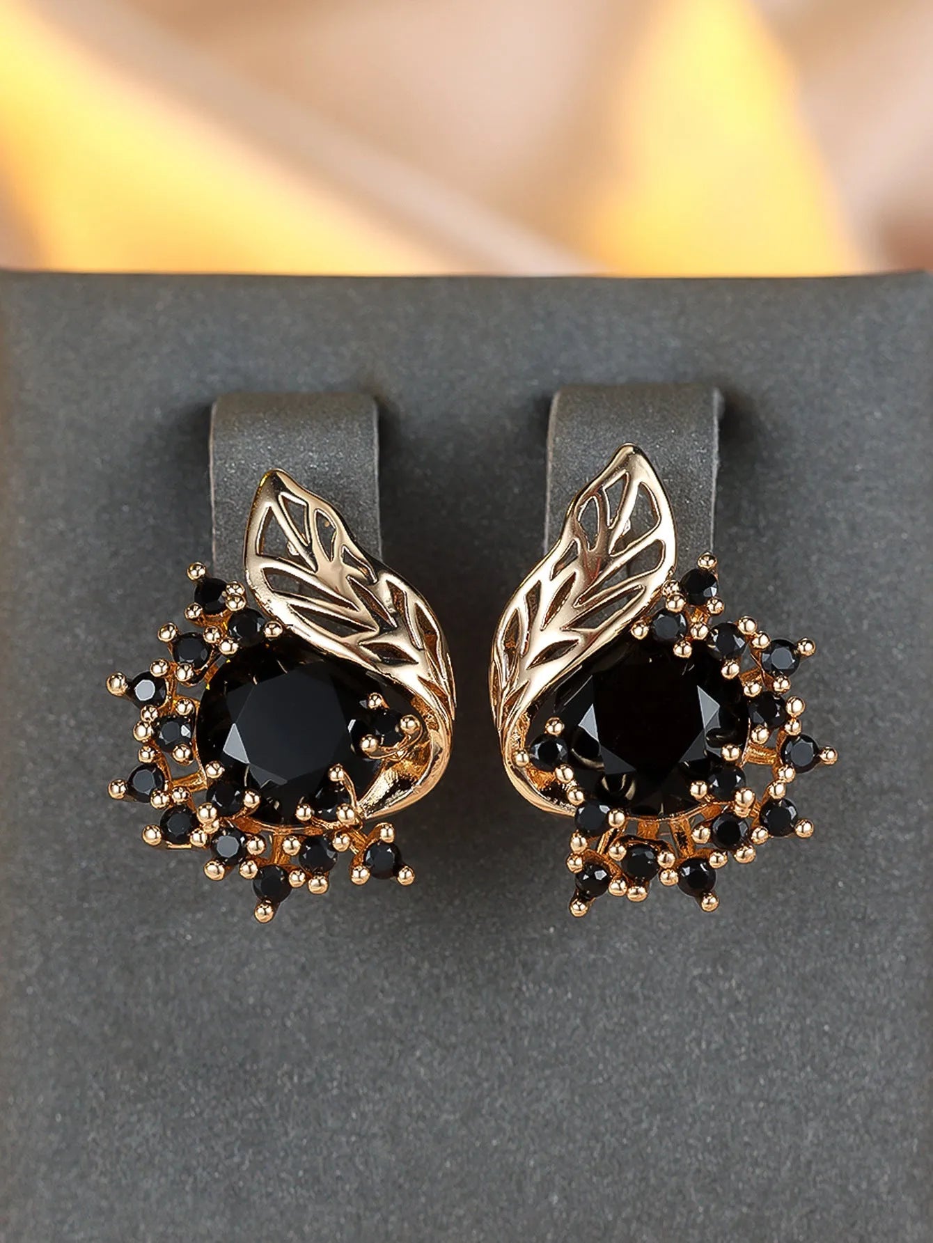 Round flower and feather design earrings in champagne gold with a choice of coloured zircon stones.