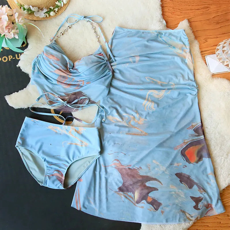 Women's blue print bikini set with triangle top, pants, and skirt, showing steel support structure.