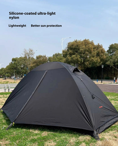 Single person tent with aluminium poles, silicon coating, and double-layer design in black colour, set up outdoors