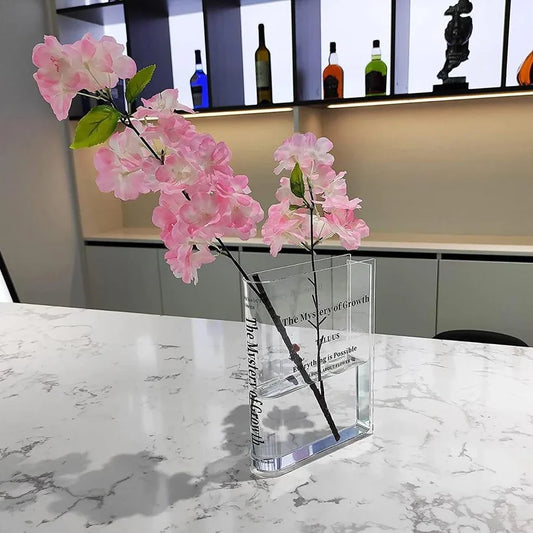 Transparent book-shaped acrylic vase, 22cm long with black font, refracting sunlight for home decor