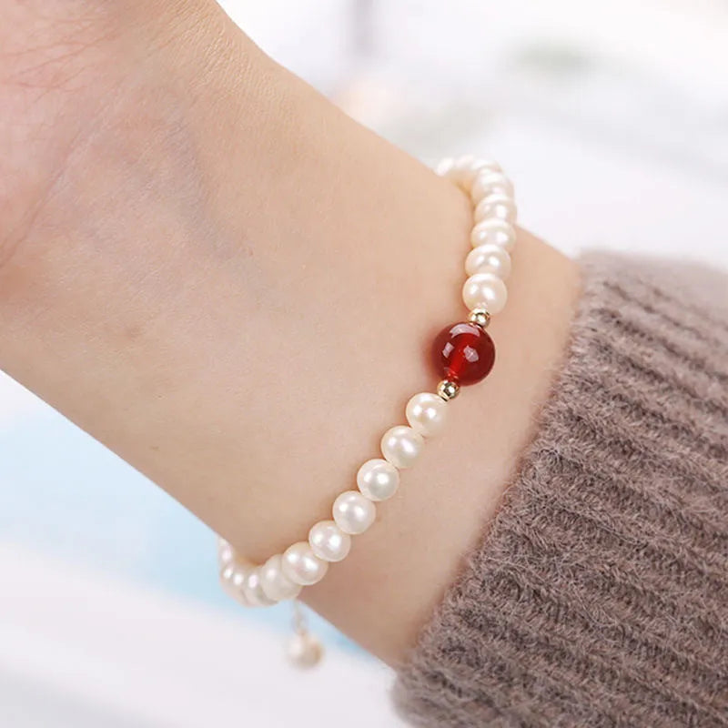 Chinese style glass bead bracelet with bamboo joint design on wrist.