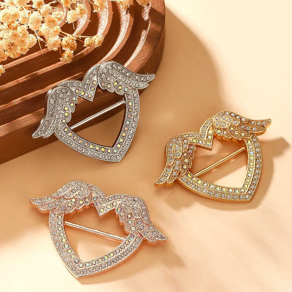 Bow-shaped waist-cinching accessory clip for high-end brooches, alloy with electroplating and diamond inlay, shown in gold, silver, or rose gold finishes.