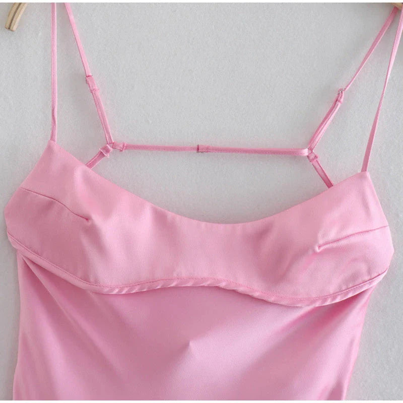 Elegant satin slip dress in pink with a flattering, form-fitting silhouette and sexy backless design