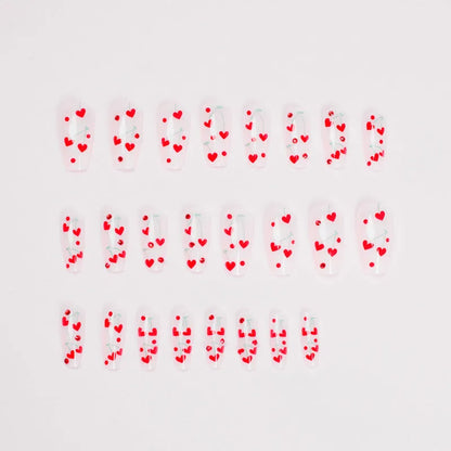 Sheet of 24 red diamond and cherry patterned nail art stickers with a small tube of adhesive glue.