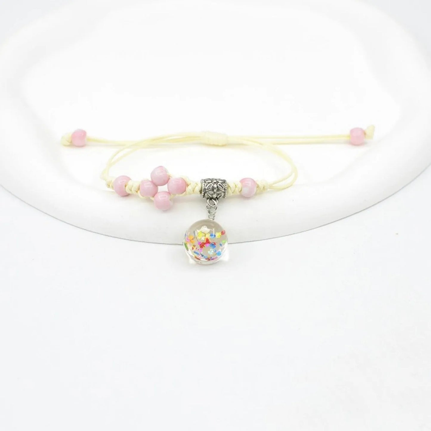 Hand-woven glass bracelet with large 1.4 cm beads containing real dried flowers, shown in blue.