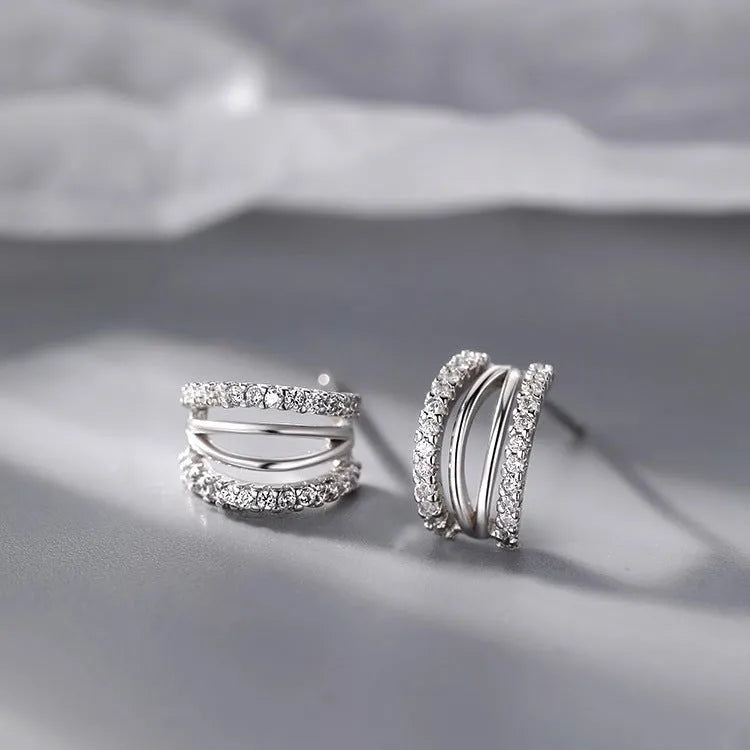 A pair of geometric-shaped 925 sterling silver earrings with a polished finish on a white background.
